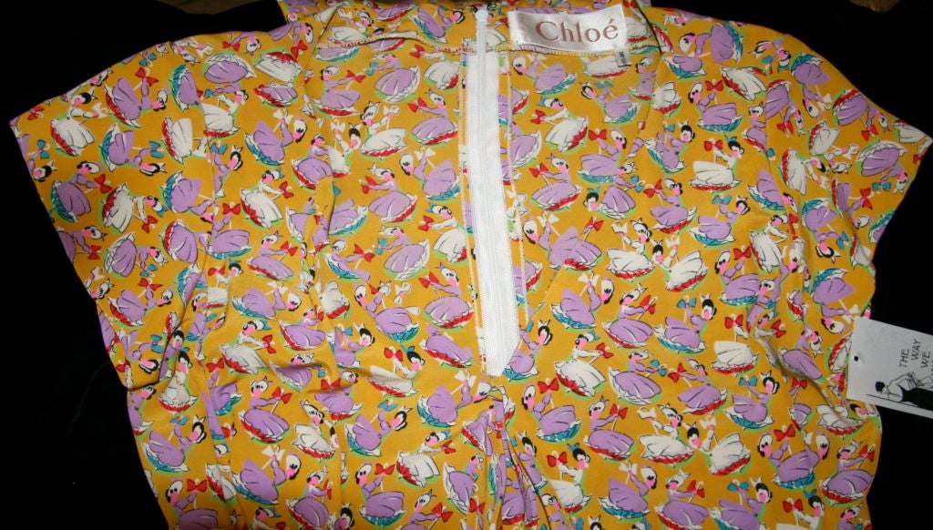 Lagerfeld's last collection for Chloe circa 1978-79. Yellow sun dress, 1940s inspired, fun print with maidens wearing bonnets, purple and white in blue, red and white umbrellas. Adjustable ties with coiled hem attached to the collar, can be tied in