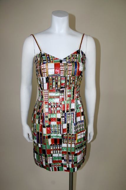 Todd Oldham multi colored cocktail dress with beaded spaghetti straps. Sequins and beads in cross hatch geometric pattern. Red, green, blue, white, black and gold. Sweetheart top at bodice with beaded spaghetti straps. Red satin lining, sewn in,
