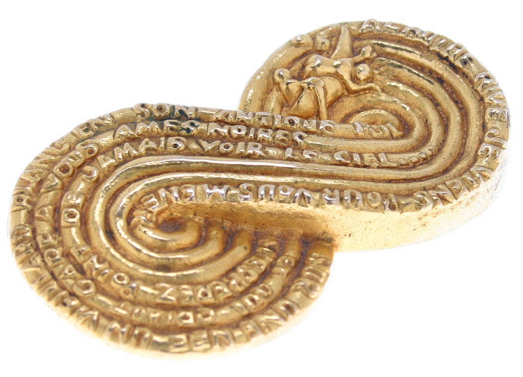 This fabulous brooch, in the form of the infinity symbol, features text from Dante's Inferno.  It is stamped LV