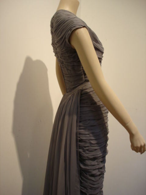 Smoke chiffon ruched gown with a detachable train. No label.