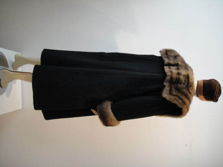 Yves Saint Laurent Fourrures!  The softest black cashmere fabric is paired with the finest Russian Sable in this dramatically comfortable, chic outerwear!  With its generous squared fur lapels and cuffs, dropped shoulder, black silk lining, and