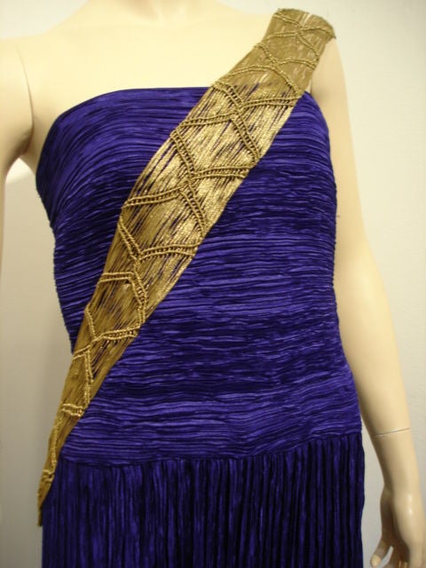 Purple silk Fortuny-style pleated gown with a gold macrame/lame sash.