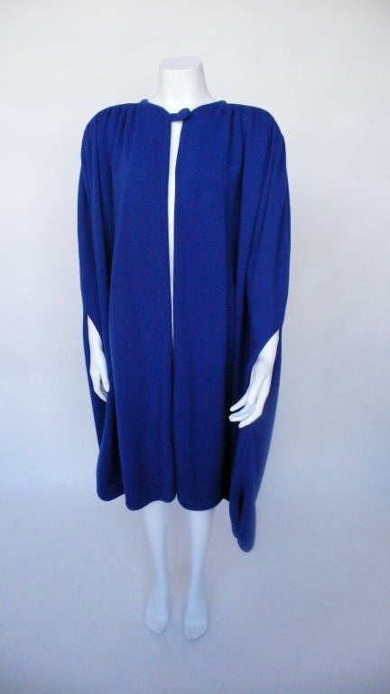 Long cape, with detailing hand slits, rouching at shoulders, lightly padded.