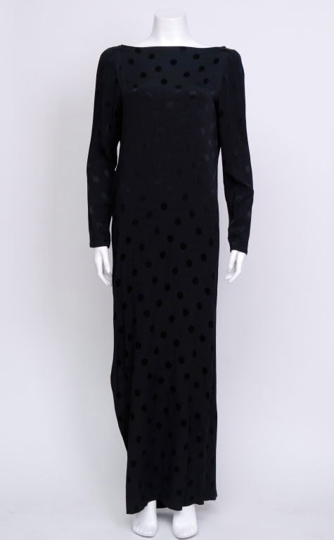 Oscar De la Renta black silk, polka-dot pattern, long sleeve , low-cut back gown with flower applique and side slit to mid leg.