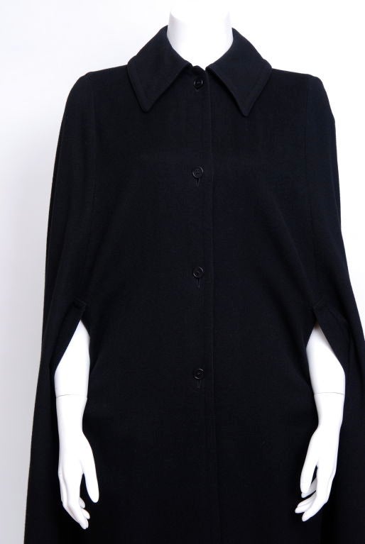 Black woven wool cape with 4 buttons and arm holes, no wear to the fabric.