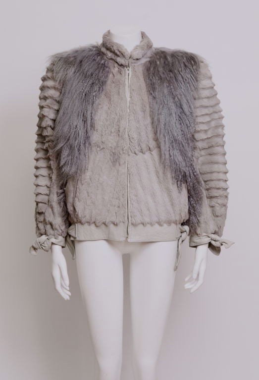 Sheared beaver fur with Mongolian lamb accented on the chest and shoulders both front and backside. Sleeves are trend friendly featuring the dolman sleeve. Leather tie accents on the wrists and waist. Shoulder pads.