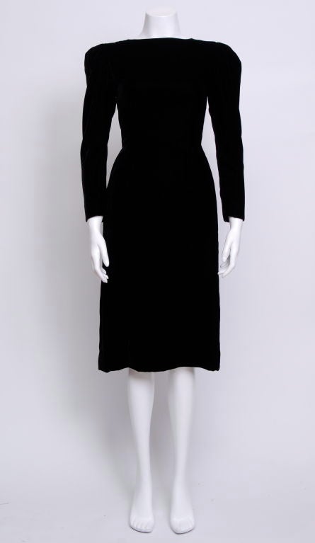 Lanvin's romatically long sleeve velvet cocktail dress. Featuring a deep V in the back with an oversized bow, and flowing pleats.