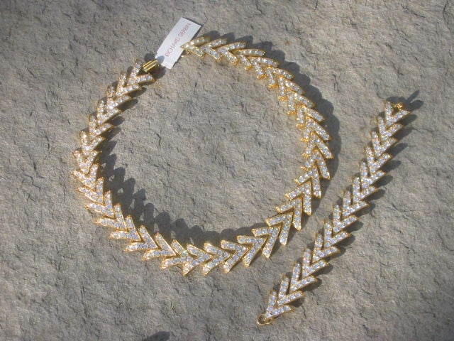 Gorgeous Vintage Crystal Necklace & Bracelet Set from Richard Serbin<br />
<br />
This lovely set is made of casted gold tone metal that are V shaped links. Each link is encrusted in genuine Swarovski Austrian crystals. The links curve beautifully