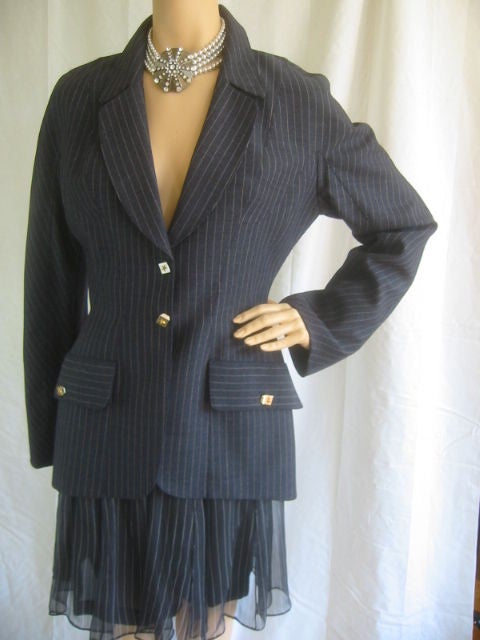 This gorgeous suit is made of a lightweight wool in a wonderful shade of Denim Gray /Blue. Jacket is designed with a chic signature Mugler Star buttons and Mugler's signature body hugging fit that cinches the waist. The jacket has lovely rounded