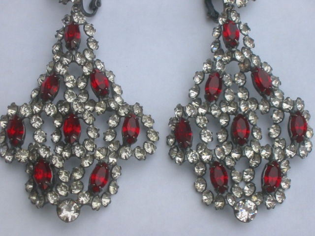 Fabulous Crystal 1960's Chandelier Earrings from Kenneth Jay Lane<br />
<br />
Made of genuine Swarovski Austrian crystals with gunmetal plating. Each piece is meticulously soldered together to create these beautiful earrings. They're made with a