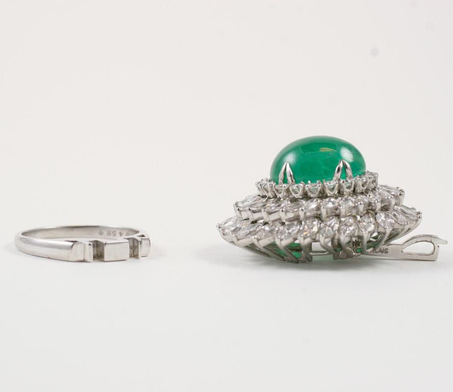 Very large platinum, diamond and emerald ring that converts into a pendant. Approx. 9 carts of very white diamonds surround a cabochon emerald. Diamonds are marquis shape and round shape.

Emerald measures about 15 x 12 mm. Face of ring is about