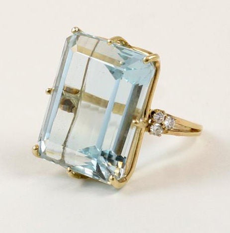 Over 50 carat aquamarine ring with 6 diamonds (approx.total wt. of diamonds 30 pts). Shank is 14K yellow gold. The top of the aqua is approx. 25mm x 21mm.