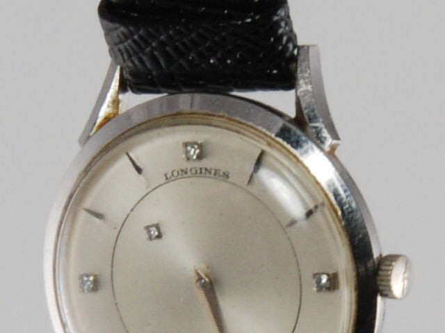 Men's 14k white gold Longines mystery watch. Instead of an hour hand, the hour is noted by a small diamond that moves to indicate the time. The watch is in working order and is a wind up movement.