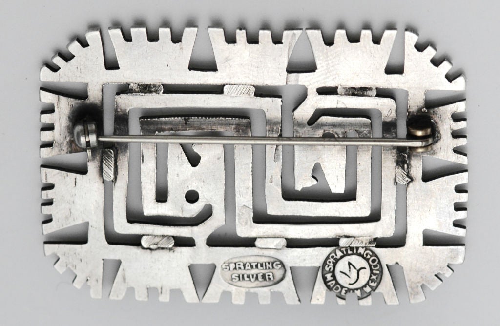 A fine circa 1939-1940 sterling silver pin by William Spratling, of Taxco, of Pre-Columbian clay-stamp design.  <br />
<br />
Dimensions:  2 1/4 inches long by 1 1/2 inches wide.  No monogram. Marked as illustrated in photo. (Pictured in catalog