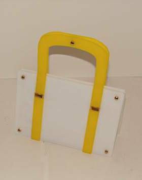 Rare lucite handbag in white and yellow.  The size is small enough to use for evening or day.  Over the years, we have had a couple of the larger lucite bags by Koret, but not this smaller size.<br />
<br />
The interior has the distinctive Koret