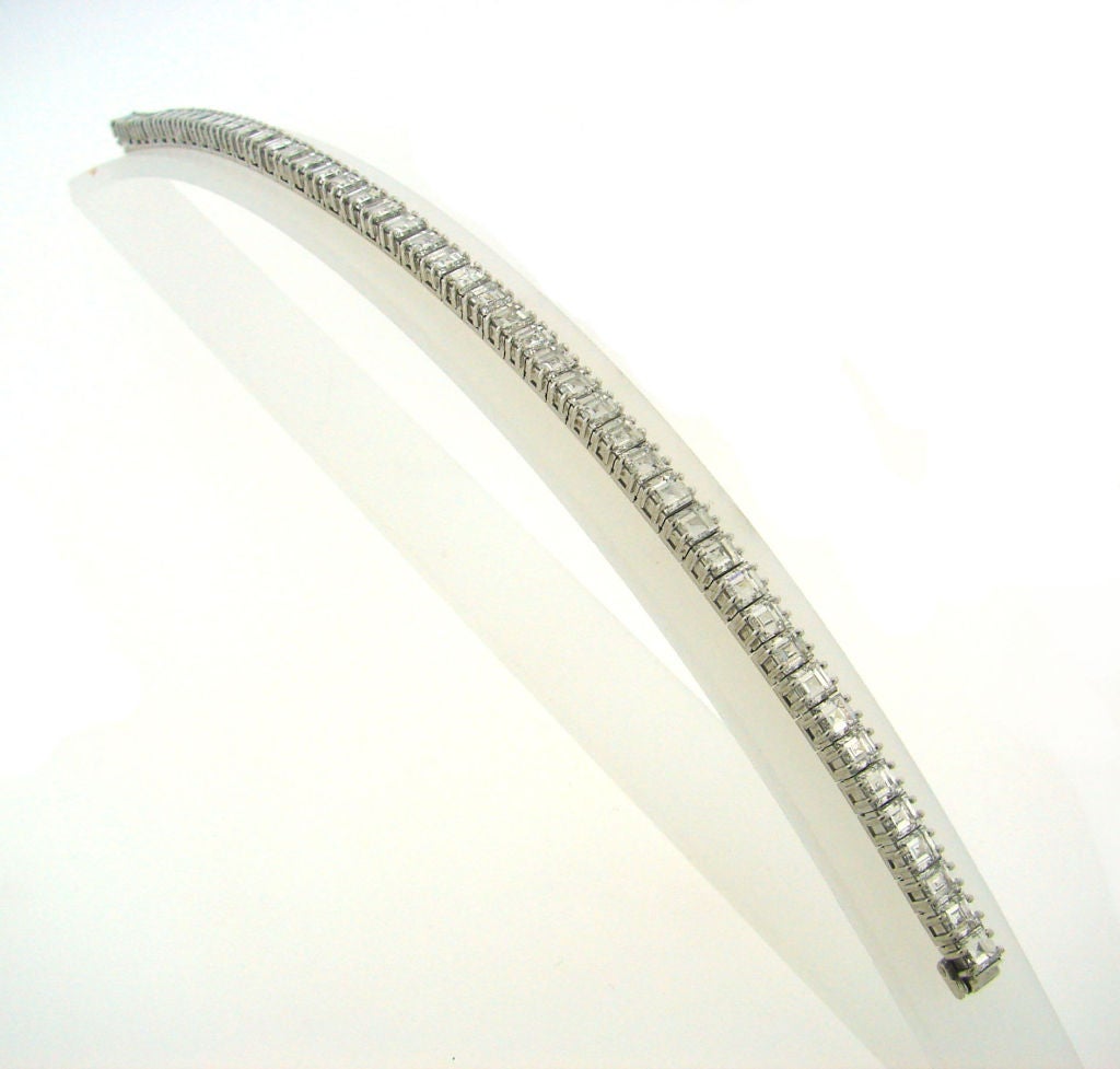 Stunning diamond tennis bracelet created by Boucheron, Paris in the 1960s. It is made of platinum and features 48 carre cut diamonds (E-F color, VVS clarity, total weight approximately 14.40 carats).
Stamped "Boucheron Paris".
Length -