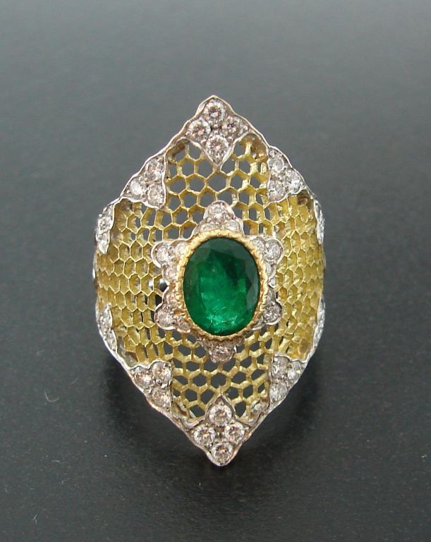 Buccellati Honey Comb design yellow and white gold ring with<br />
1.11 cts oval shape Colombian emerald, 58 round brilliant cut diamonds of total weight 1.12 cts<br />
Size 6.5<br />
Comes in original box