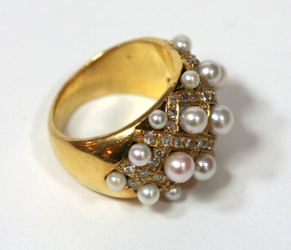This ring is almost identical to the Chanel version, but without a signature. It features culture pearls set in a diamond-set grid.