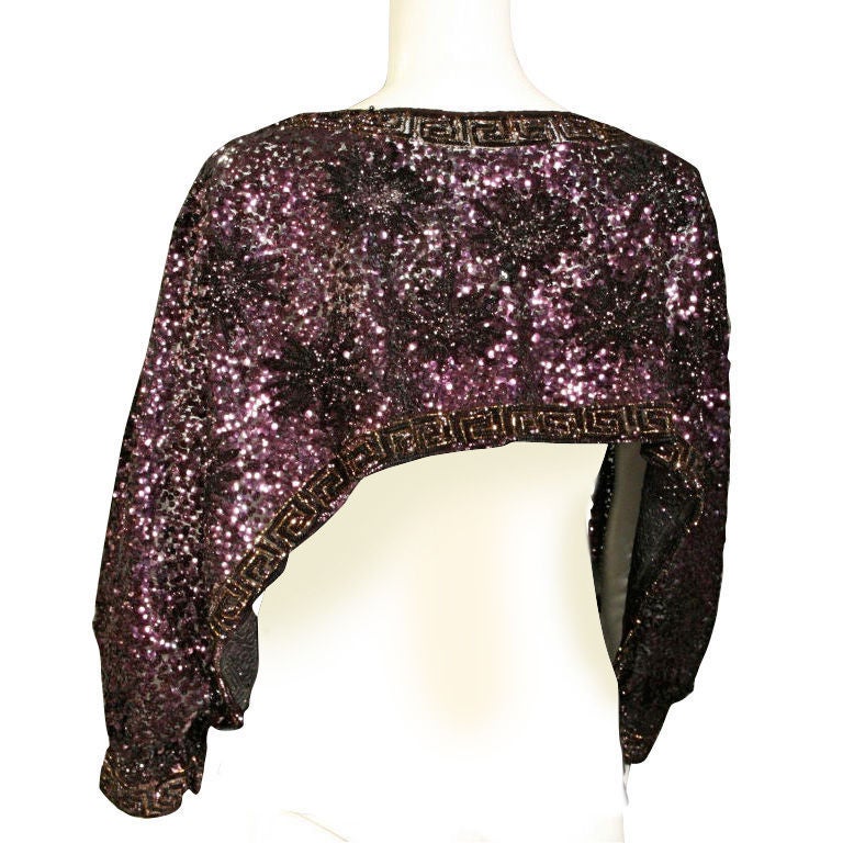 This is an amazing sequin shrug with 1940's style split sleeves and is  made in France. It has eggplant, black and copper sequins with a pattern of black flowers and Greek keys sewn on thin layer of lace. The tag is older not as white as the photo