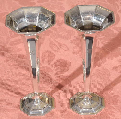 A pair of classic Tiffany trumpet vases. This style became popular around 1910 and remains popular to this day. One of the panels is engraved with a beautiful multi-lined monogram of 'GM'. The height of this pair of vases is 6 1/2 inch.