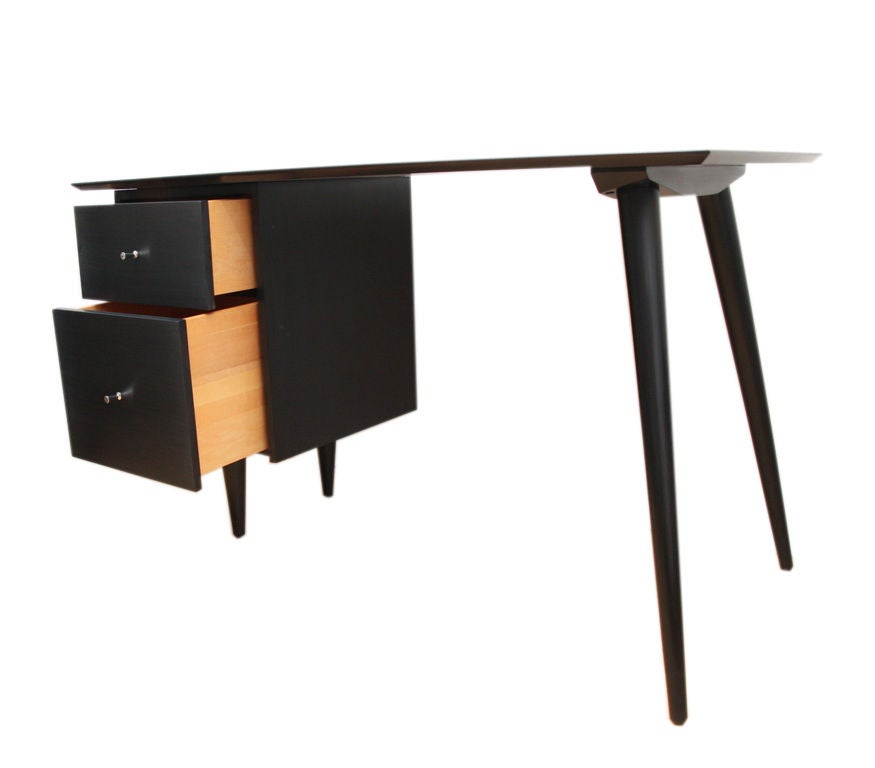 Signature style Paul McCobb 2 drawer Planner Group desk, restored to perfection in a black lacquer piano finish. Solid maple construction throughout, with solid brass conical drawer pulls. Lower drawer is perfect for files with upper drawer