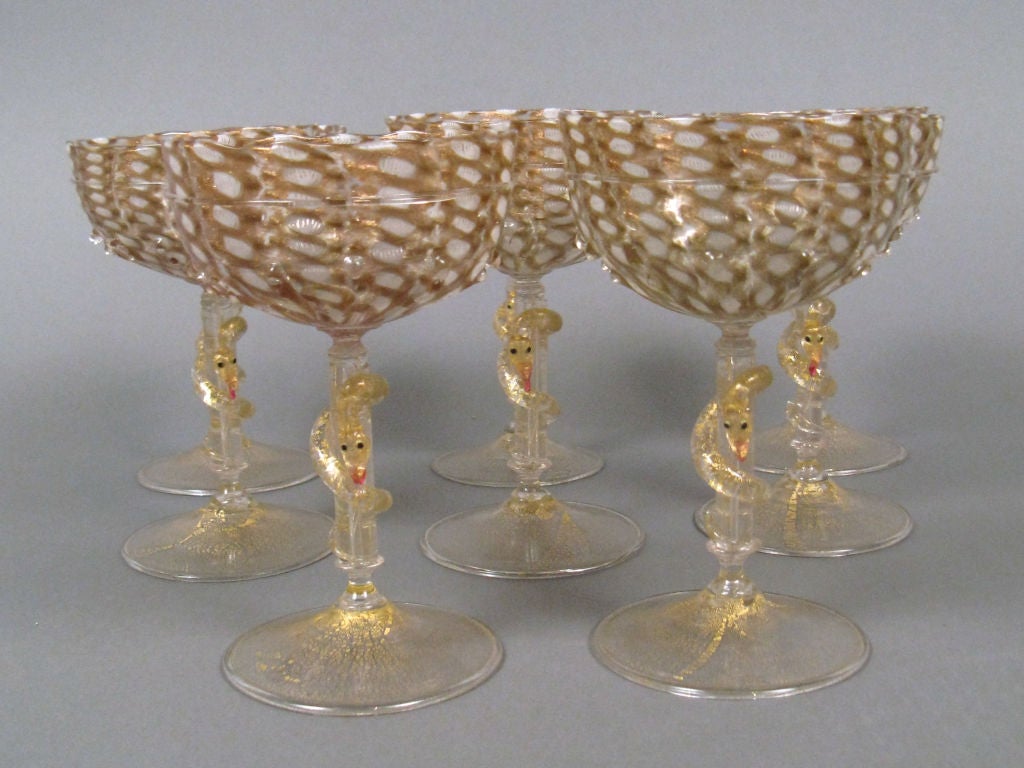 A rare set of Murano glass champagnes made by the Barovier Brothers or Salviati.  Each  glass is perfect and displays numerous elaborate and difficult to execute techniques.  Being hand blown no two glasses are alike in shape or height. The <br