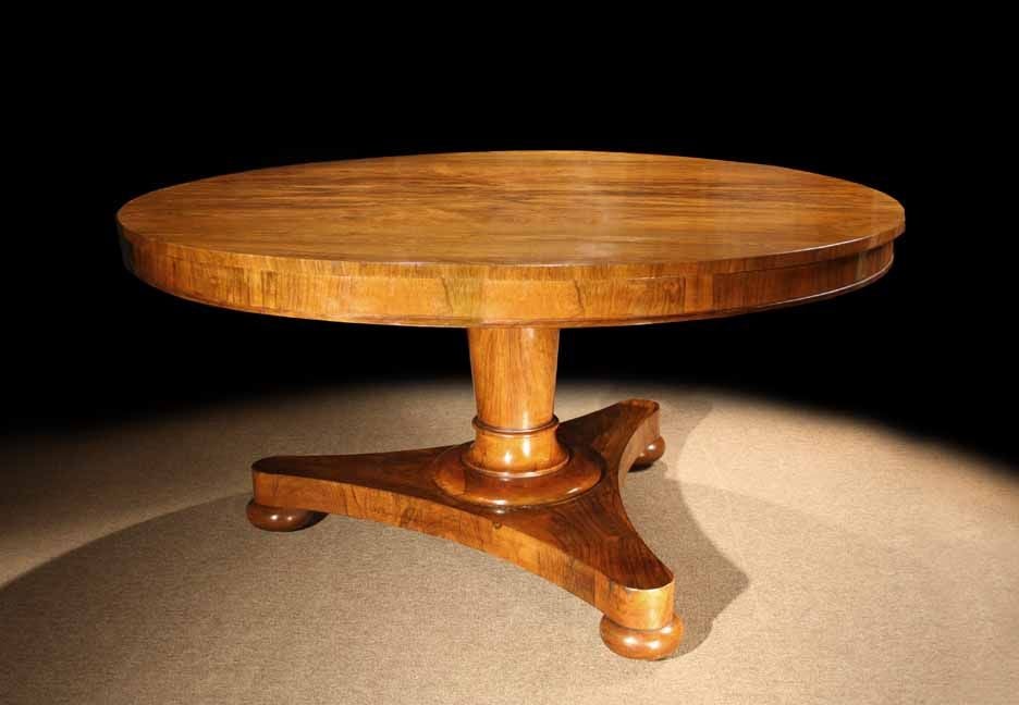 # S539 - Beautifully figured with matched veneers, this handsome Regency rosewood center table (dining table, breakfast table) has mellowed to a pretty color. Below the apron is tapering cylindrical column which rests on a triform base and bun
