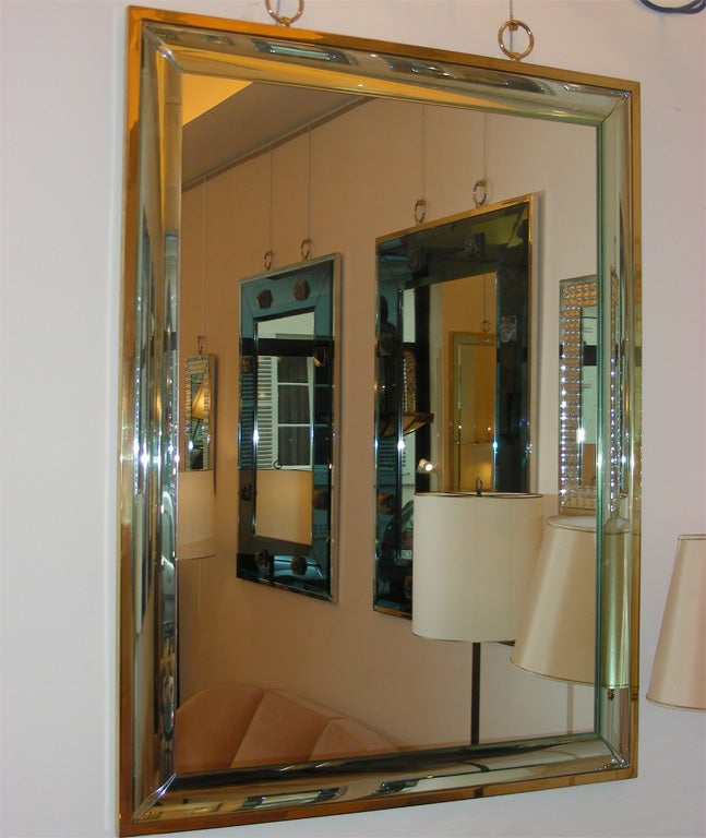Large contemporary mirror by André Hayat. Frame is edged in gilt bronze and a curved magnifying glass segment.