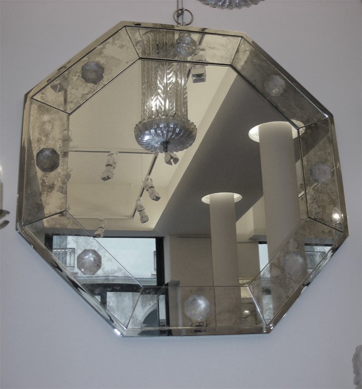 Octagonal mirror by André Hayat. Silver bronze edge, frame in oxidized mirror and cut rock crystal inserts like diamonds. Height is given with ring.