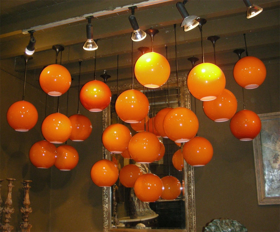 1970s set of 20 orange opaline ceiling lights with their original hanging system and height ranging from 50 to 100 cm.