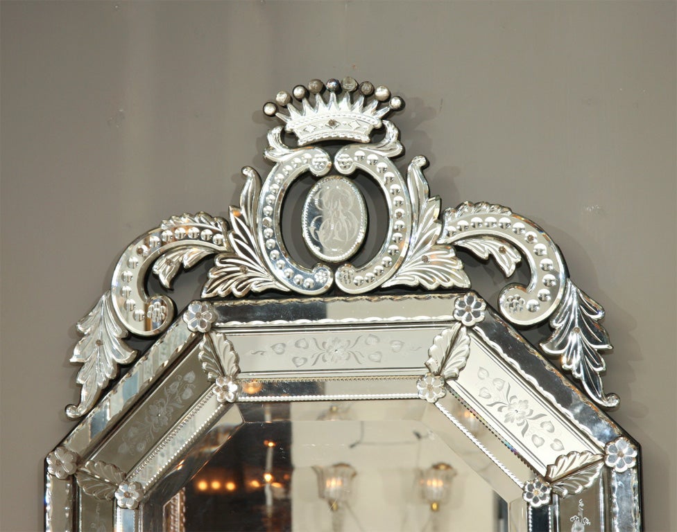 Elongated octagon Venetian cushion mirror with crown.