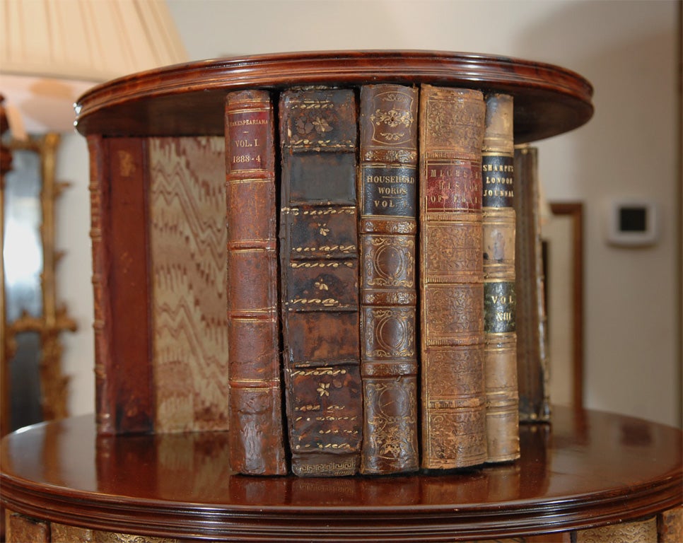 revolving Georgian mahogany bookcase with 19th leather bound book binds attached, all original.