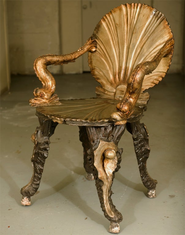 Pair of carved and painted grotto armchairs, hand carved dolphin form arms over silver leaf seat on shell form legs. All original finish.