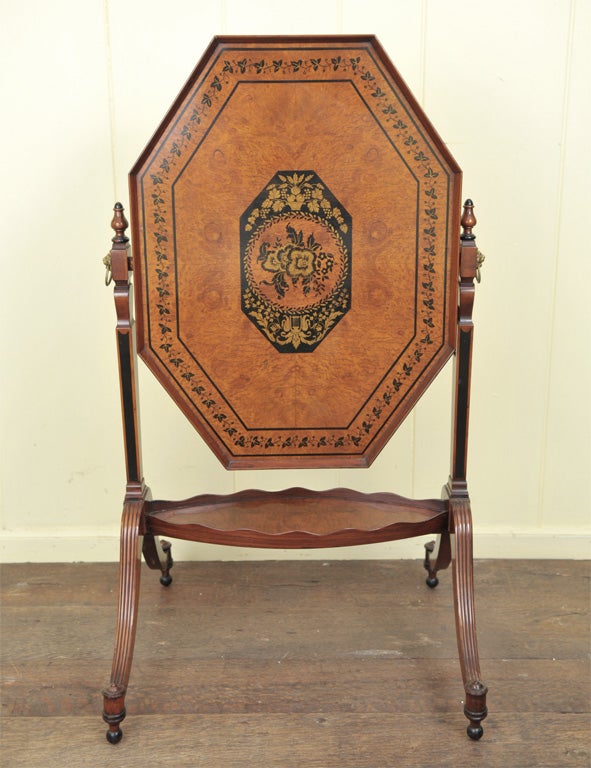 A British Aesthetic Movement octagonal tilt-top tray table with burl wood inset top and mahogany framing. Complex 'ebony' and gilt leaf penwork decoration. There is also a narrow secondary tray with scalloped gallery, which serves as a trestle