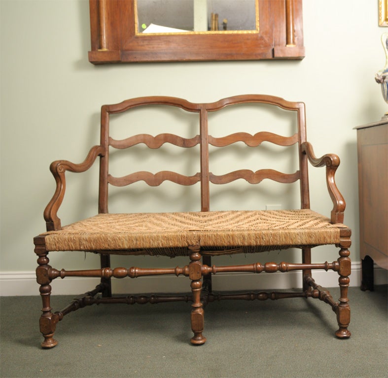 Early 19th century Italian Provincial bench in walnut with rush seating from northern Italy, first quarter of the 19th century