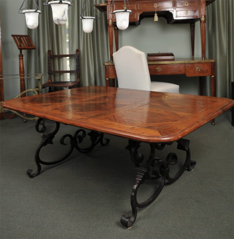 One of a kind table made with antique walnut parquet flooring (rare to find in walnut) with a thick gauged wrought iron scrolled base
price reduced from $6500/ no longer available to order with antique walnut parquet top.