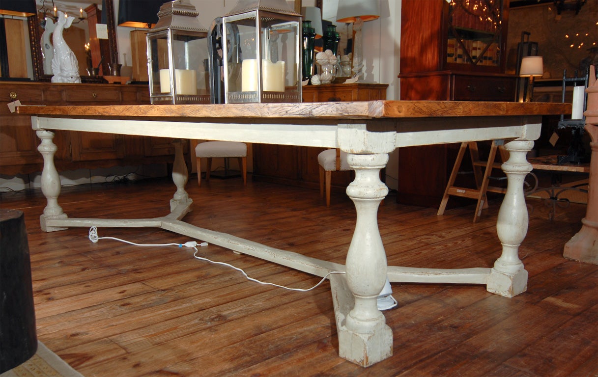 A long plank top dining table assembled out of antique timber removed from a country structure in Wales dating to 1820 and placed on a base comprised of old posts joined by a distinctive stretcher from Great Britain. Please notice the luscious deep