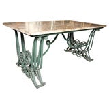 Table with ornate wrought iron base by Raymond Subes