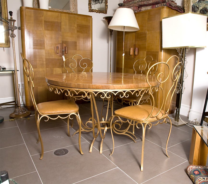 Round wrought iron table with veneered top and 6 chairs by Jean Charles Moreux