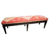 VINTAGE WOOD BENCH UPHOLSTERED W/A 19TH  C. KILIM RUG