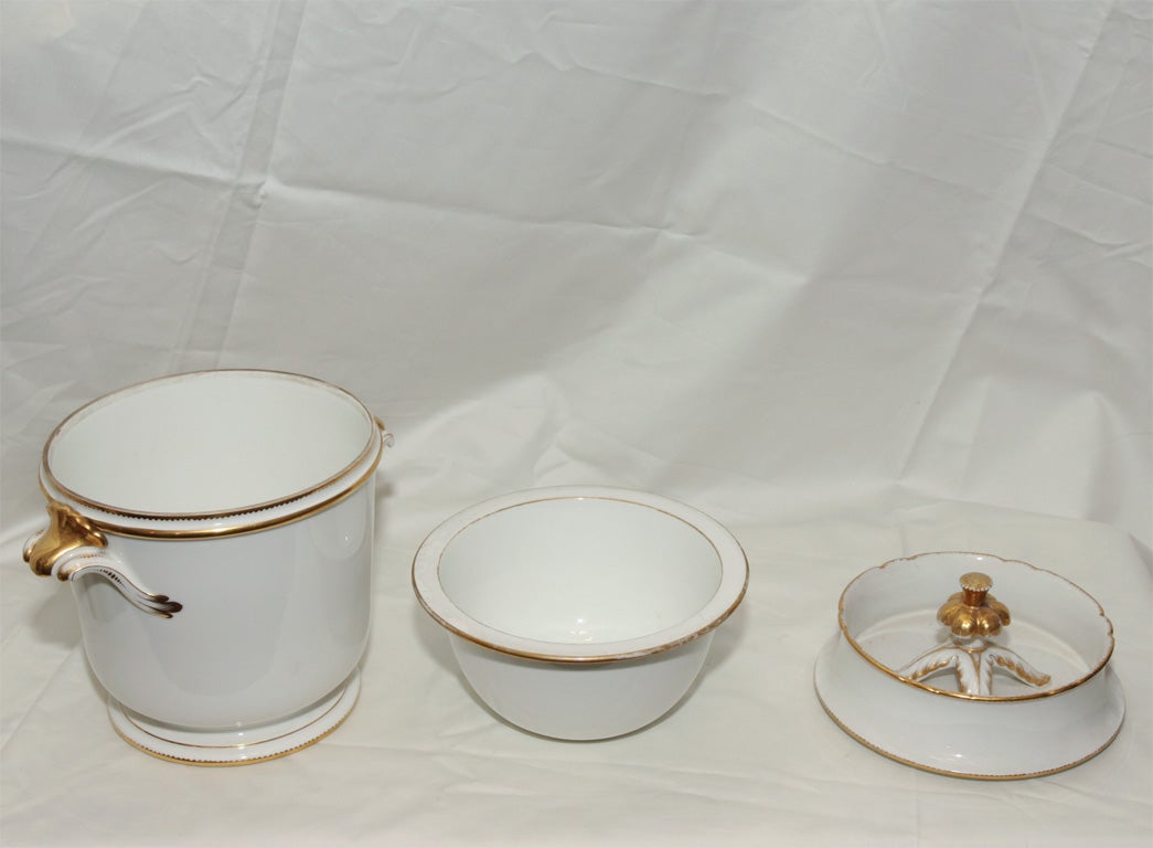 Pair of 18th century French white and gilt fruit coolers ( ice pails) liners and covers with gilded shell shaped handles and elegant gilt finials.