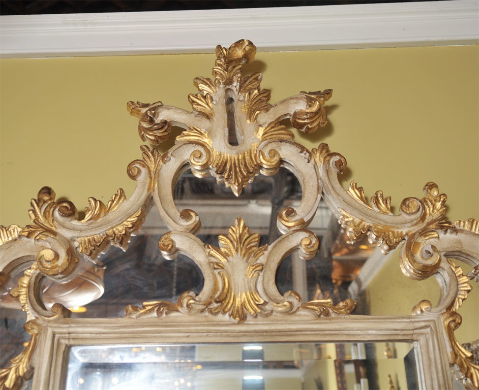 Beautiful parcel and gilt decorated over the mantle mirror.