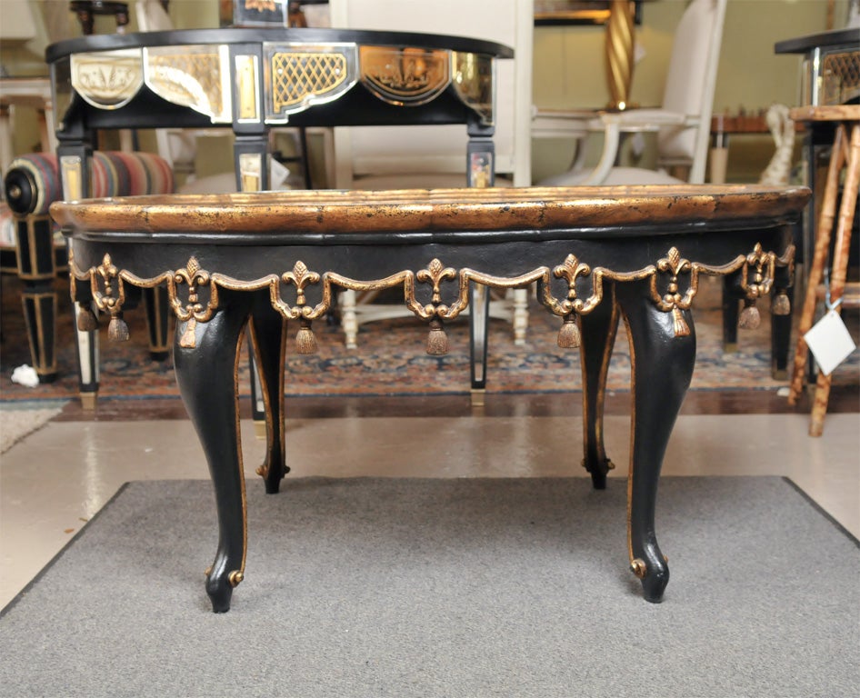 This item is a fine, gilt decorated ebony painted coffee table with an etched glass top. Fine Louis XV Style foot leading to a carved cabriole leg supporting a gilt and ebony decorated framed top with a carved gilt apron. The top glass mirrored