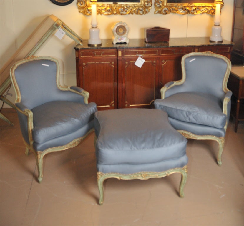 Green paint decorated and parcel-gilt Louis XV style three piece Duchesse Brisee with new upholstery stamped Jansen. Ottoman measures 27w, 24d, and 36.25h.