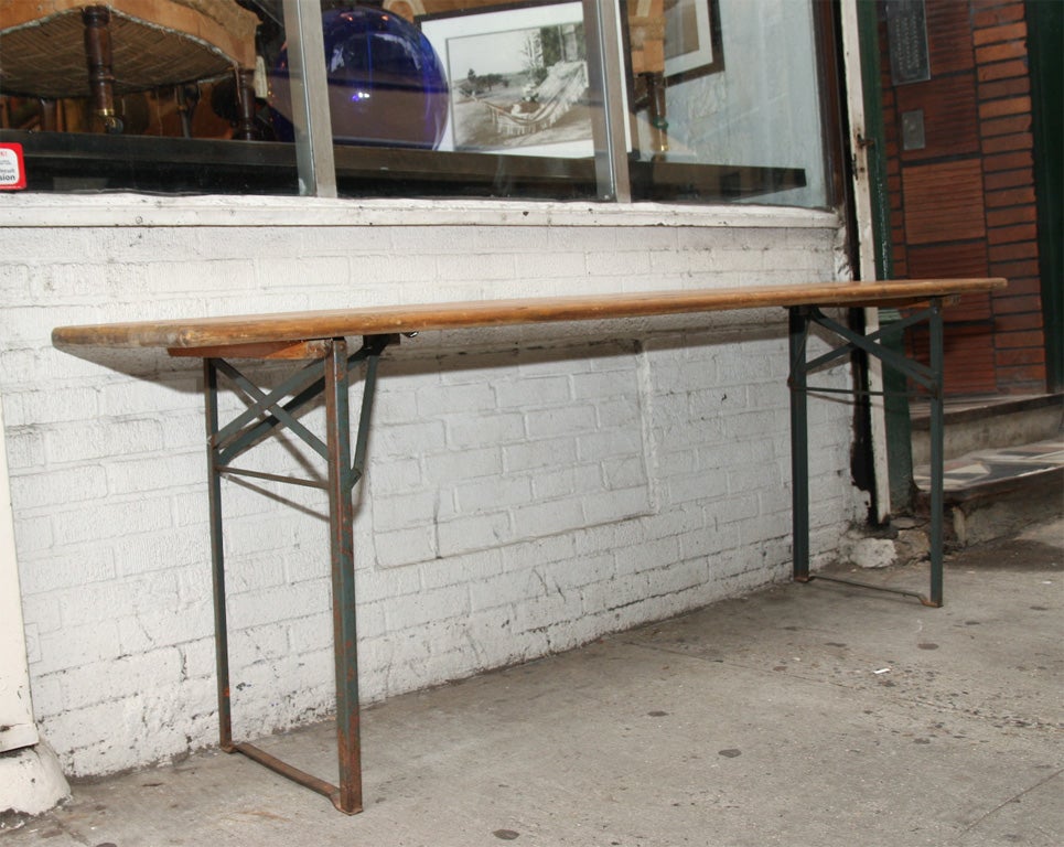 Table from a Biergarten in Munich, Germany. The legs of both the  table fold flat for winter storage. Great worn patina.