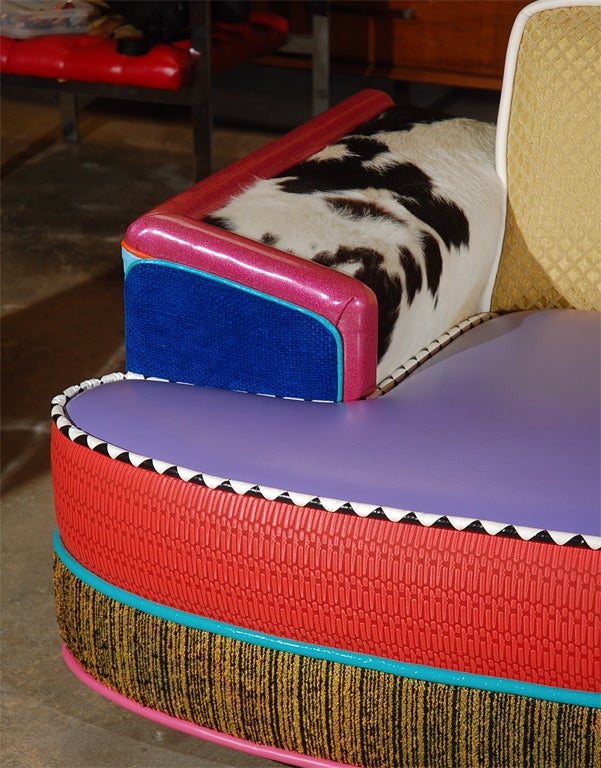 A one of a kind Memphis inspired sofa by 1980's Los Angeles designer Harry Siegel, executed in a motley assortment of fabrics and textures ranging from black and white pyramid pattern piping to purple vinyl seat and highly textured panels  of