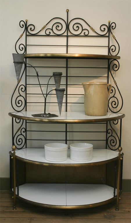 Four-tier iron with brass detail, baker's rack.  White glass shelves.