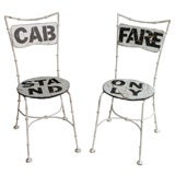 White wrought iron "Cab Stand:" and "Fare Only"   chairs