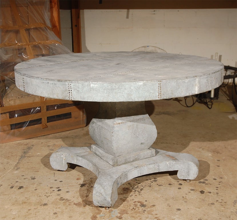 Great looking zinc clad antique pedestal table on original casters. Good as center table or dining table. Good for covered outside areas. Super charming