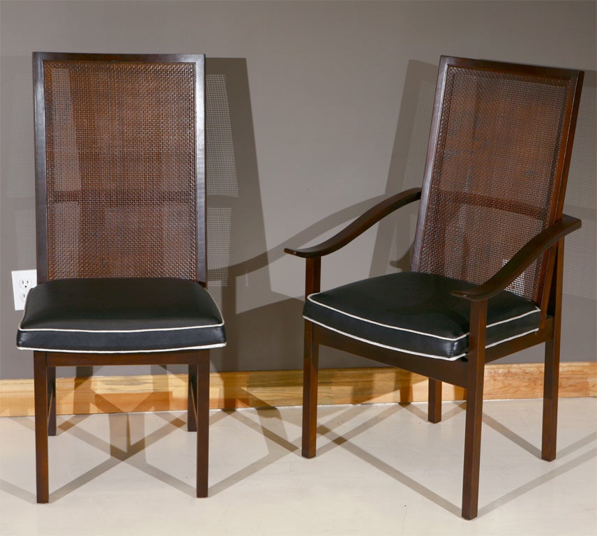 High-backed walnut dining chairs by directional with caned back and upholstered seats.  Two arm chairs and four armless chairs.